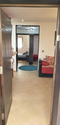 a view of a living room with a bed and a mirror at SALICORNE 1 marina saidia appt in Saïdia