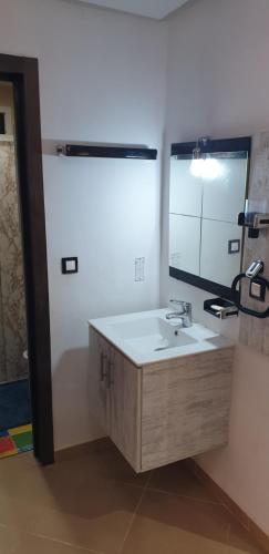 a bathroom with a sink and a mirror at SALICORNE 1 marina saidia appt in Saïdia