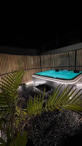 a swimming pool in a backyard at night at Nascer Do Sol Retreat Villa in Conceição