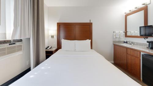 a hotel room with a large bed and a bathroom at Comfort Inn Gaslamp Convention Center in San Diego