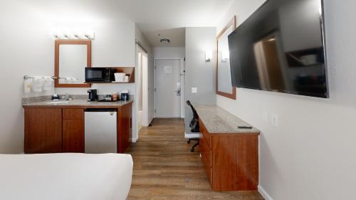 a room with a kitchen with a desk and a television at Comfort Inn Gaslamp Convention Center in San Diego