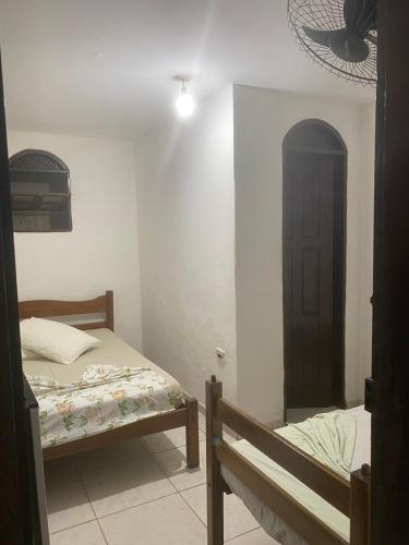 Ein Bett oder Betten in einem Zimmer der Unterkunft Raízes Pousada