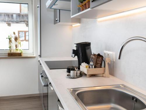 a kitchen with a sink and a counter top at Tirolee Marchegg in Oberau
