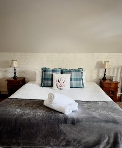 a bedroom with a bed with a towel on it at Woolmers Estate in Longford