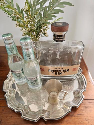 a tray with two bottles of water on a table at Country Style in the City - Close to Airport in Sydney