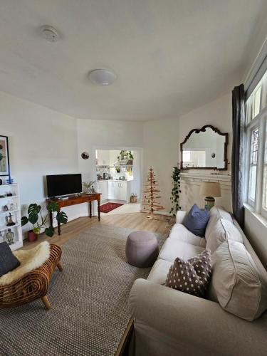a living room with a couch and a piano at Country Style in the City - Close to Airport in Sydney
