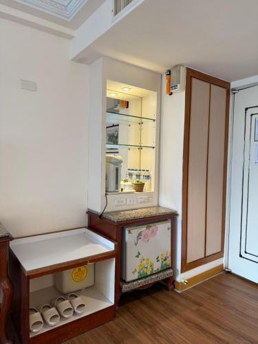 a room with an empty refrigerator with a shelf at Hua Tong Hotel in Hualien City