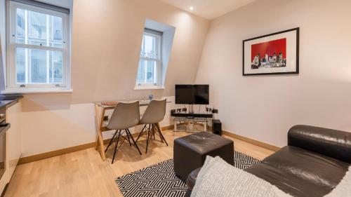 a living room with a couch and a table at Bank Serviced Apartments by LovelyStay in London