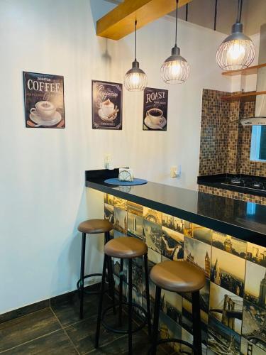 a bar in a restaurant with stools and posters on the wall at NatuCenter Hospedaje in Puerto Presidente Franco