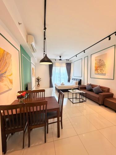 a living room with a table and a couch at Chamber KL Residence by Moon Orchid in Kuala Lumpur