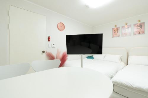 a living room with white furniture and a flat screen tv at DDM Stay 동대문 스테이 in Seoul