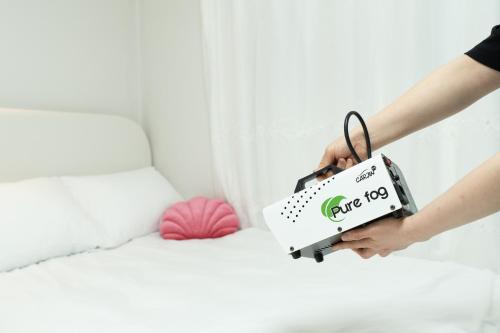 a person holding a sign on a bed at DDM Stay 동대문 스테이 in Seoul