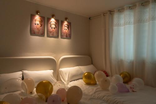 a room with a bed with balloons on it at DDM Stay 동대문 스테이 in Seoul