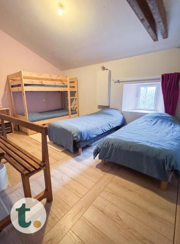 une chambre avec deux lits et un lit superposé dans l'établissement Tranquiloue - Maison spacieuse à 8min du PuyduFou, à Saint-Laurent-sur-Sèvre
