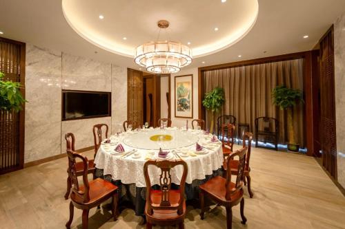 a large dining room with a table and chairs at Century Runhua Hotel in Jinan