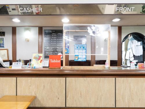 a fast food restaurant with a counter with a cashier at Tabist Hotel Ginga Kisarazu in Kisarazu