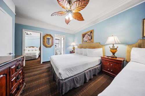 a hotel room with two beds and a chandelier at Fitzgerald Hotel Union Square in San Francisco