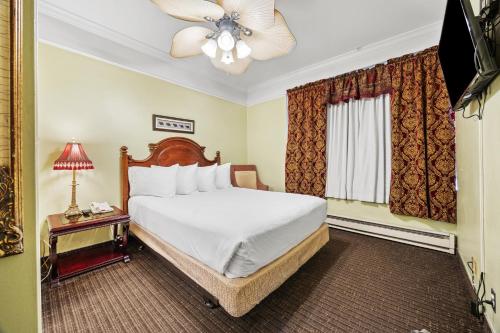 a hotel room with a bed and a window at Fitzgerald Hotel Union Square in San Francisco
