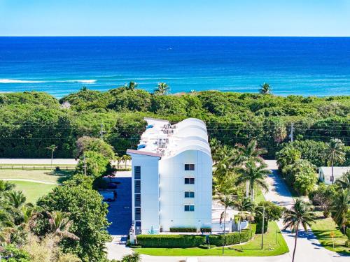 an aerial view of a white building next to the ocean at Luxury - 2BR 2BA - Balcony - Right Across From the Beach in Boca Raton