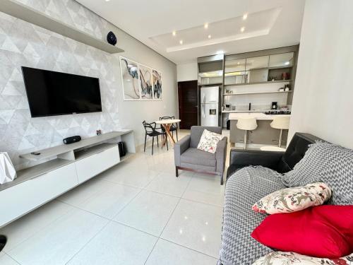 a living room with a couch and a tv on a wall at Sinop Luxury Apartment in Sinop
