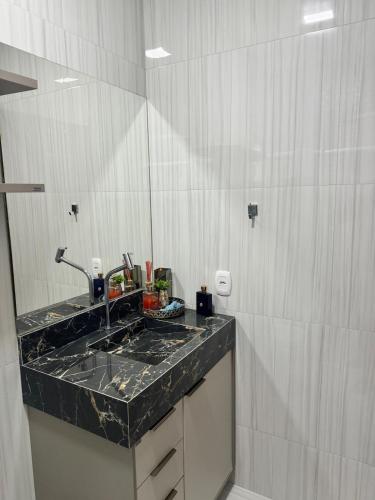 a bathroom with a sink and a counter top at Sinop Luxury Apartment in Sinop