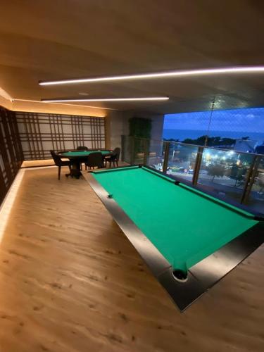 a pool table in the middle of a room at New time Pajuçara in Maceió