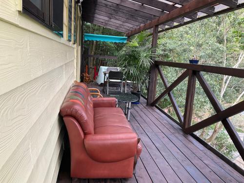 a leather couch sitting on a wooden deck at なごみの里 in Shionoe