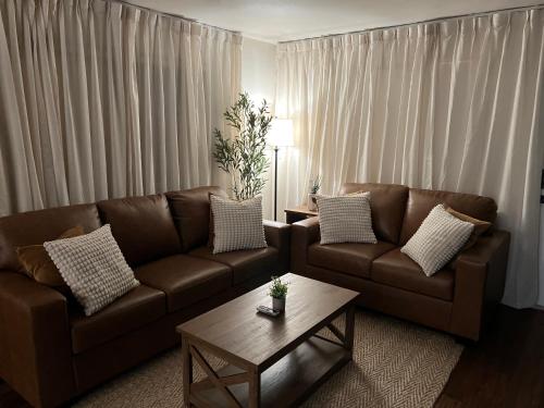 a living room with a brown couch and a coffee table at Seaside Serenity in Daytona Beach