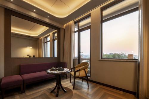a living room with a couch and a table at Xiamen Lujiang Harbourview Hotel in Xiamen