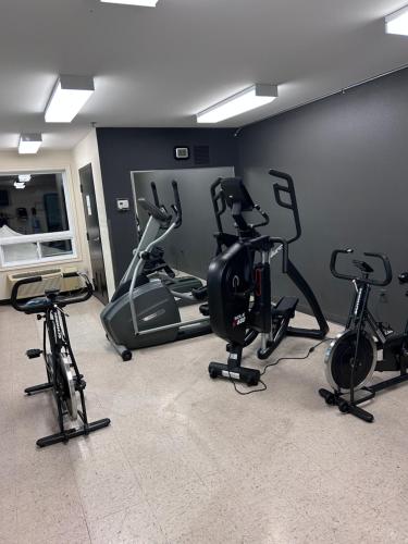 a gym with several exercise bikes in a room at Super 8 by Wyndham Trois-Rivieres in Trois-Rivières