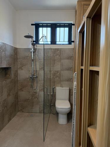 a bathroom with a toilet and a glass shower at Equinox Studio in La Gaulette
