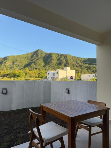 a table and two chairs on a balcony with a view at Equinox Studio in La Gaulette