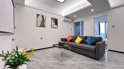 a living room with a couch and a table at House of Great White Apartment in Shenzhen