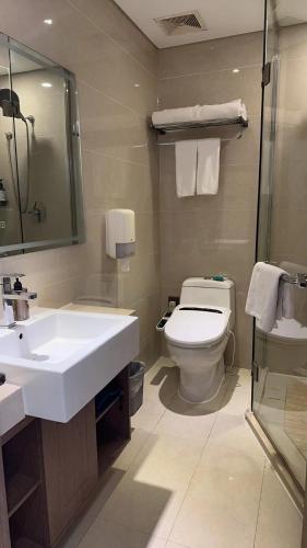 a bathroom with a white sink and a toilet at Bestway Hotel Xi'an in Xi'an