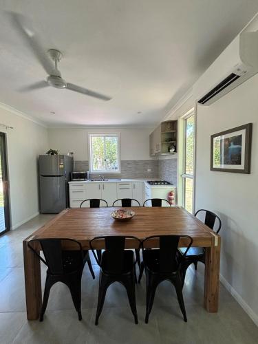 a kitchen with a wooden table and chairs at Litchfield Safari Camp in Rakula