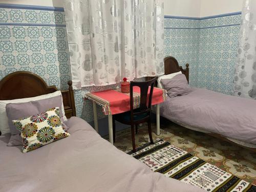 Ένα ή περισσότερα κρεβάτια σε δωμάτιο στο Chambre centrale