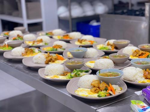 a bunch of plates of food on a table at Texas Corner Garden Resort in Xóm Tram