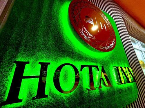 a close up of a green sign with a spider man on it at Hota Inn Limbang in Limbang