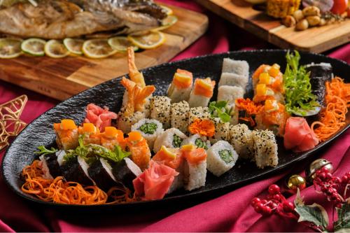 a plate of food with sushi on a table at Grand Westside Manila Bay in Manila
