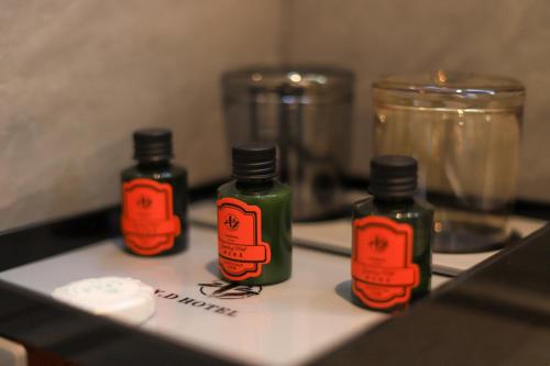 three bottles of essential oils sitting on a table at Dujiangyan Yuandong Yaju Hotel in Dujiangyan