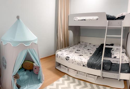 a childs bedroom with a bunk bed with a canopy at HappyCasa Splashmania in Banting