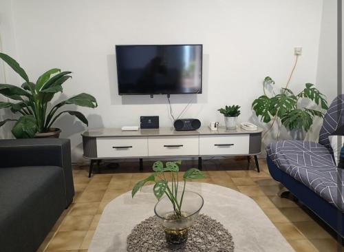 a living room with a tv on a white dresser at Summer Homestay@civic centre in Sibu