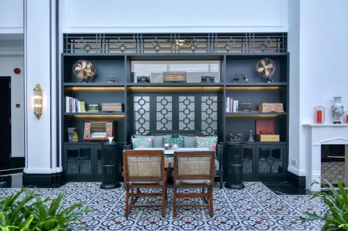 a dining room with two chairs and a table at Liu Men Melaka in Melaka