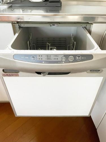 an oven with its door open in a kitchen at Mubean in Nara