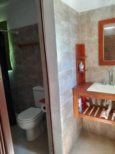 a bathroom with a toilet and a sink at Remanso in La Estancia