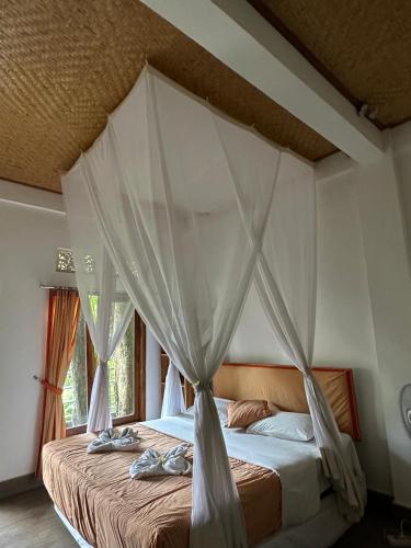 Postel nebo postele na pokoji v ubytování Omunity Bali
