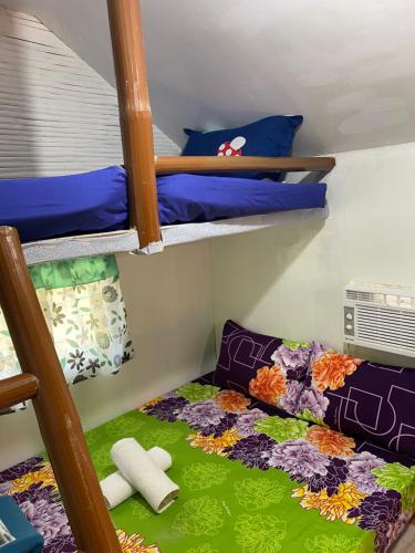 a room with two bunk beds and a bed with a comforter at Eco Park - Albur Rental Properties in Alburquerque