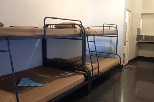 a room with three bunk beds in a room at Hotel Villarte in San Fernando
