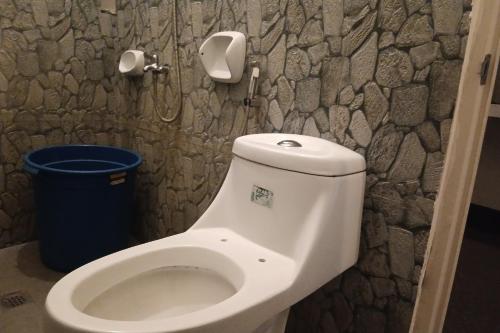 a bathroom with a toilet and a trash can at Hotel Villarte in San Fernando