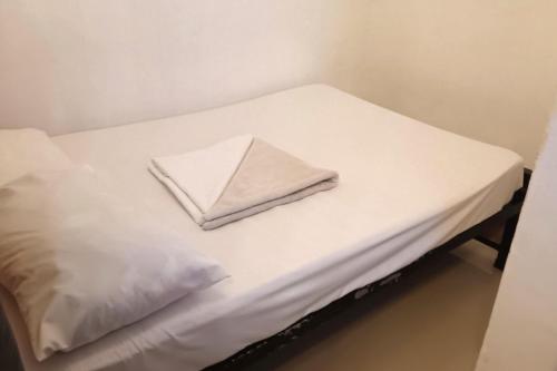 a white bed with two pillows on top of it at Hotel Villarte in San Fernando